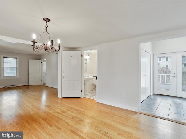 interior space featuring light wood-type flooring and an inviting chandelier