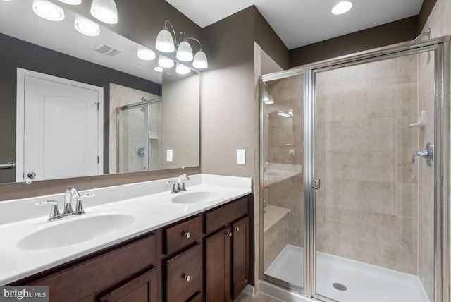 bathroom with vanity and a shower with door