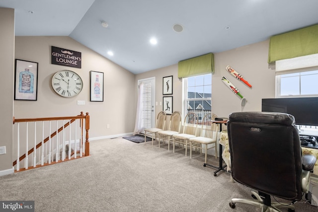 carpeted office space featuring plenty of natural light and vaulted ceiling