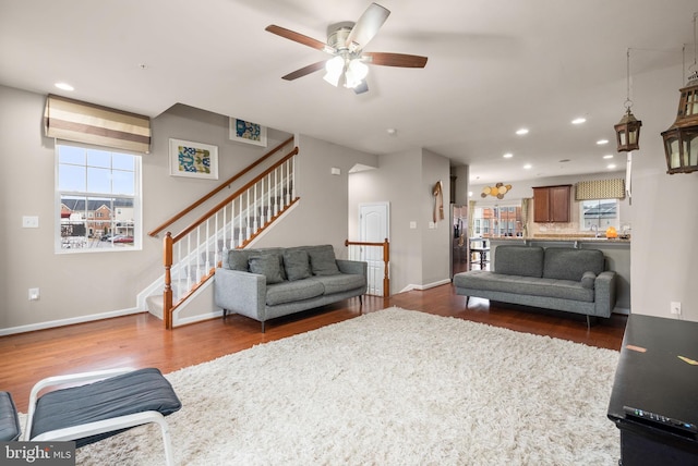 living room with ceiling fan, dark wood-type flooring, and sink