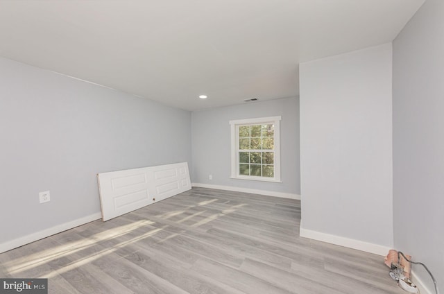 unfurnished room featuring light hardwood / wood-style flooring