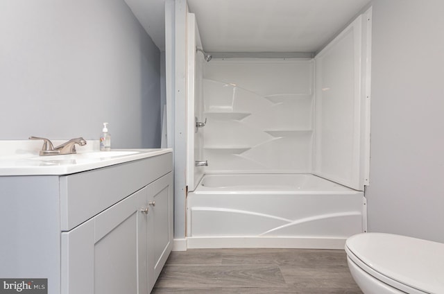 full bathroom featuring shower / bathing tub combination, vanity, and toilet