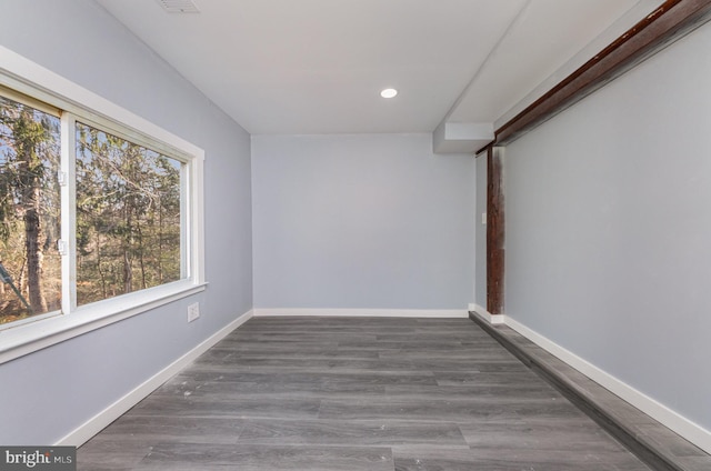 unfurnished room with dark wood-type flooring