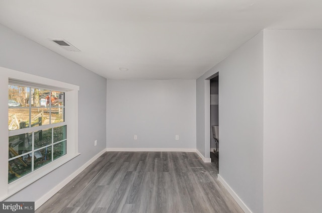 spare room with wood-type flooring