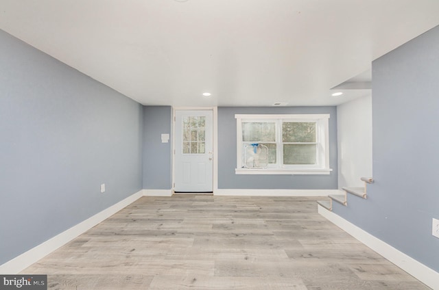 entryway with a wealth of natural light and light hardwood / wood-style floors