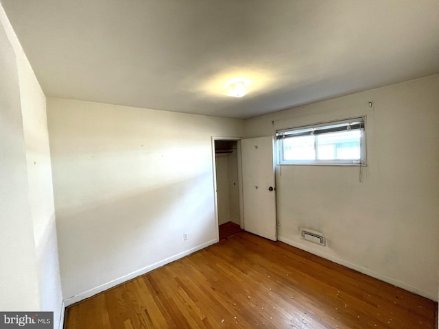 empty room with hardwood / wood-style flooring