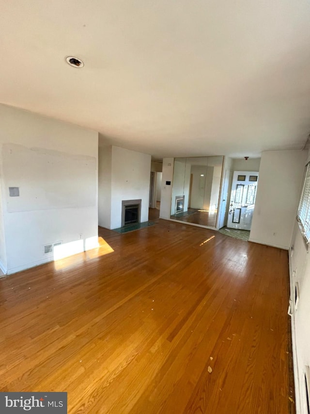 unfurnished living room with hardwood / wood-style floors