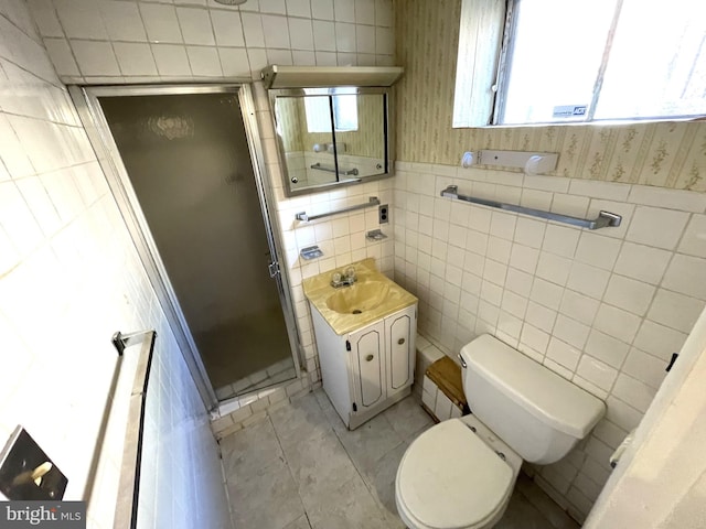 bathroom featuring walk in shower, vanity, tile walls, tile patterned flooring, and toilet