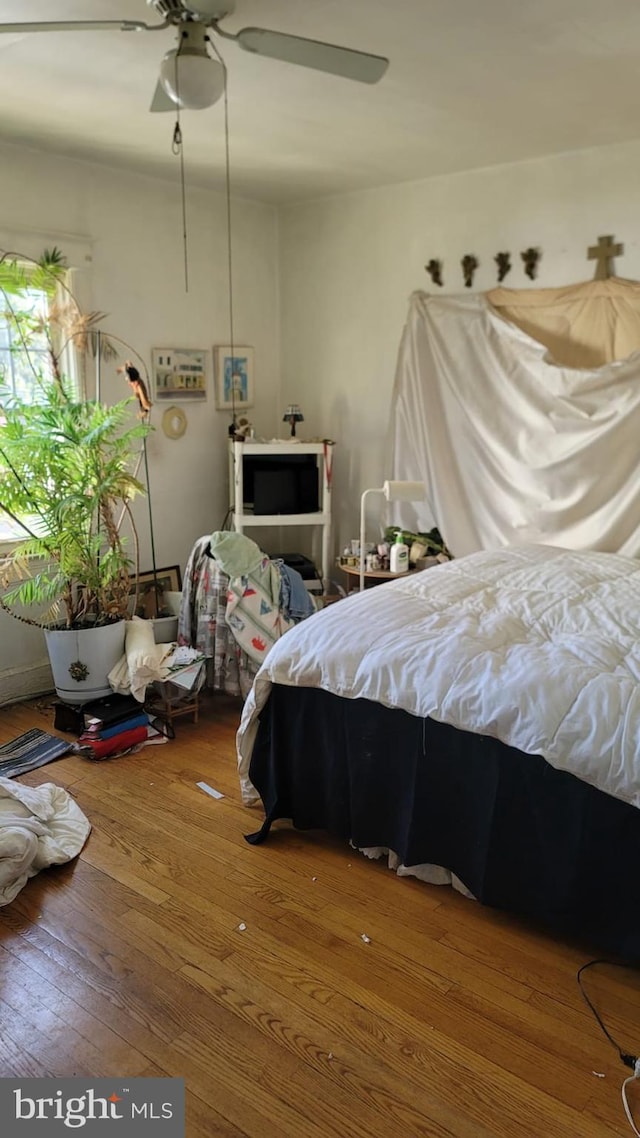 bedroom featuring hardwood / wood-style flooring and ceiling fan