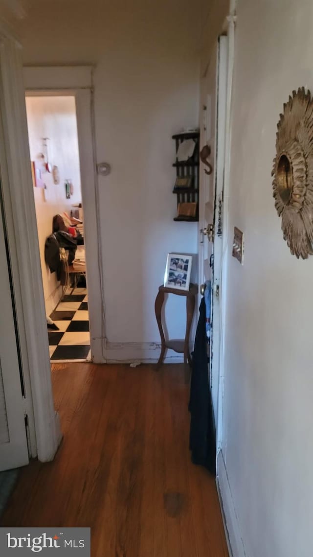 hallway with dark hardwood / wood-style flooring