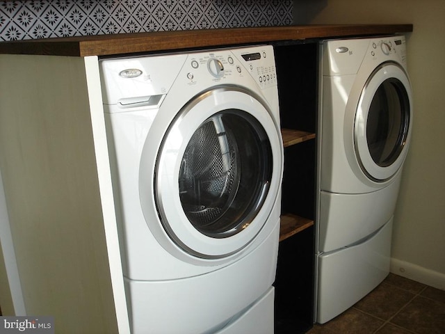 laundry room with separate washer and dryer and dark tile patterned floors