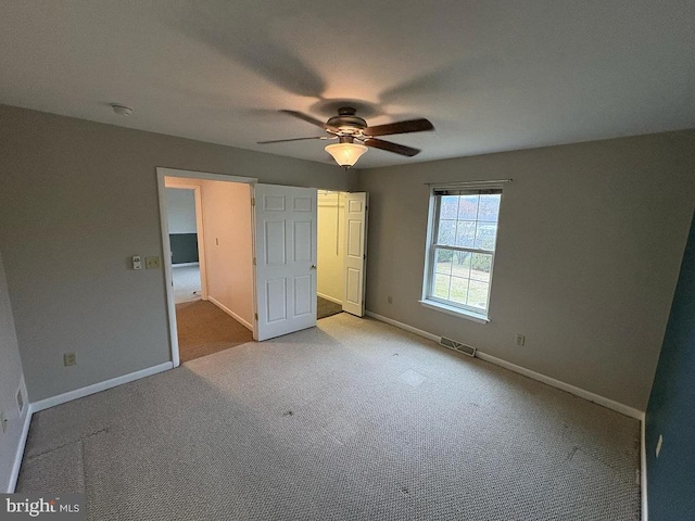 unfurnished bedroom featuring ceiling fan and light colored carpet