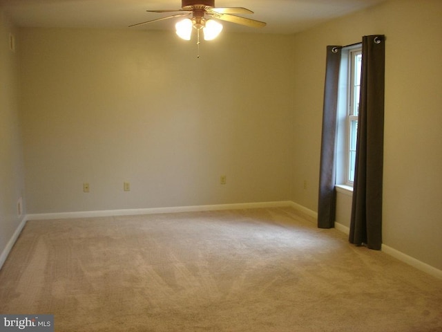 carpeted empty room featuring ceiling fan