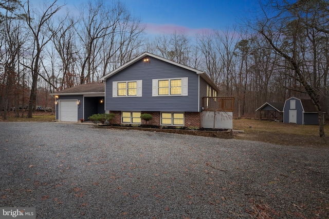 split level home featuring a shed and a garage