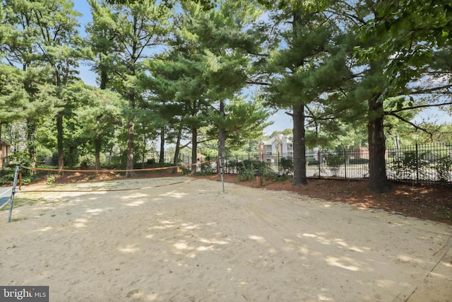 view of home's community featuring fence and volleyball court