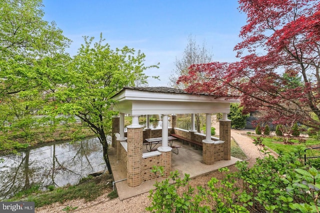 view of patio featuring a gazebo and a water view