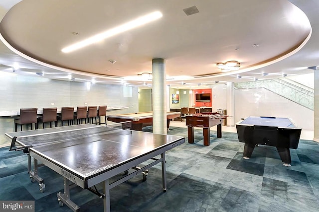 game room featuring a raised ceiling and pool table