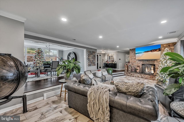 living room with ornamental molding, a fireplace, and a chandelier