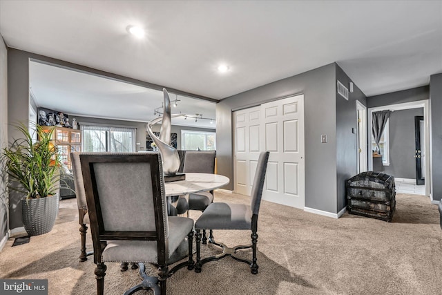 dining room featuring light colored carpet