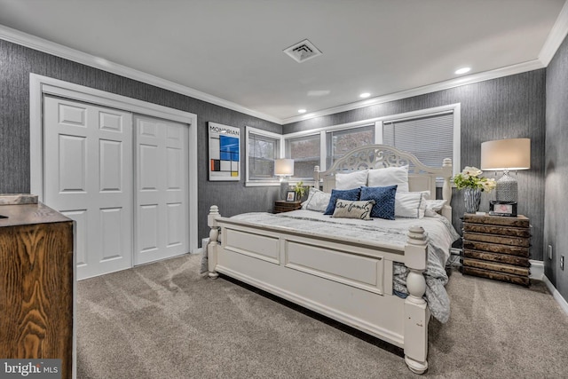 bedroom with a closet, carpet floors, and ornamental molding