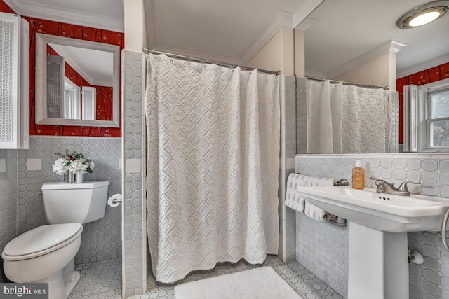 bathroom featuring walk in shower, tile patterned floors, crown molding, toilet, and tile walls