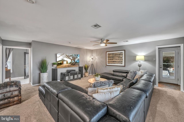 carpeted living room featuring ceiling fan