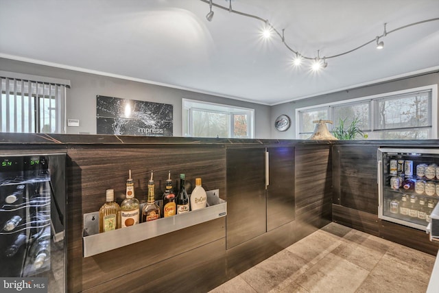 bar with wine cooler and ornamental molding