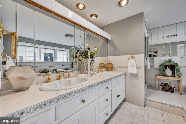 bathroom featuring tile patterned flooring, vanity, and tile walls