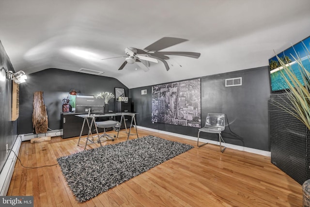 office featuring baseboard heating, ceiling fan, wood-type flooring, and vaulted ceiling