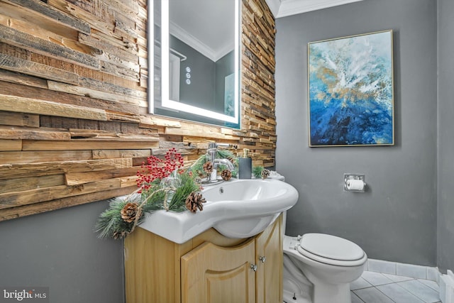 bathroom featuring tile patterned flooring, vanity, toilet, and ornamental molding