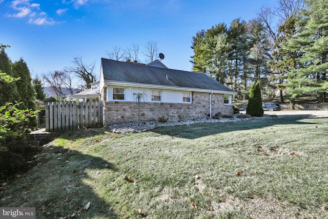 view of side of property featuring a lawn