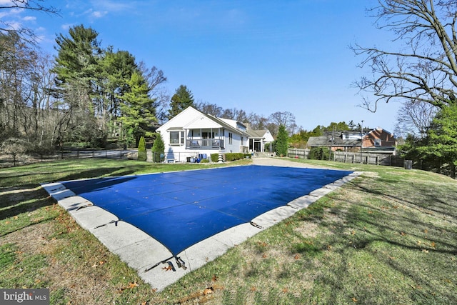 view of swimming pool with a yard