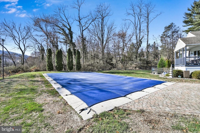 view of swimming pool with a yard and a patio area