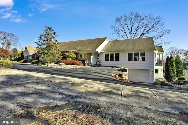 view of front of property featuring a balcony and a garage