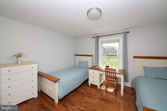 bedroom with dark wood-type flooring