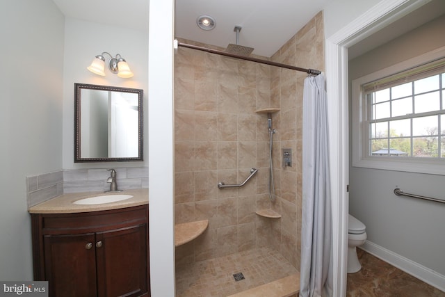 bathroom featuring a shower with curtain, vanity, and toilet