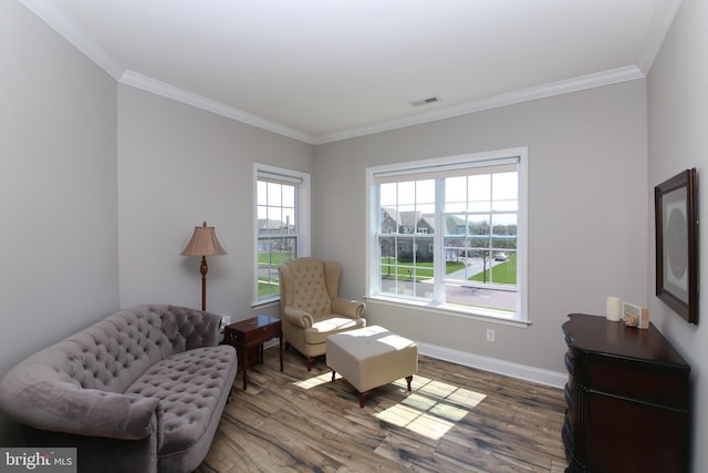 living area featuring wood-type flooring and crown molding