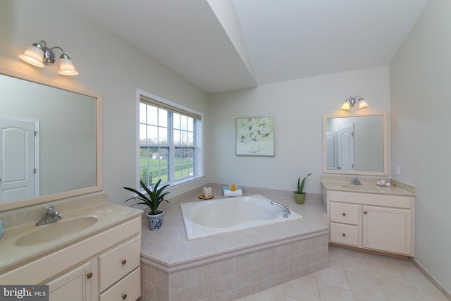 bathroom featuring vanity, tiled bath, and tile patterned floors