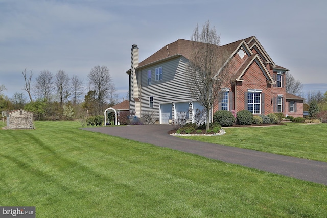 view of side of home with a yard and a garage