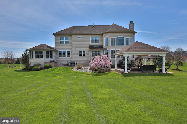 rear view of house with a gazebo, an outdoor hangout area, a yard, and a patio