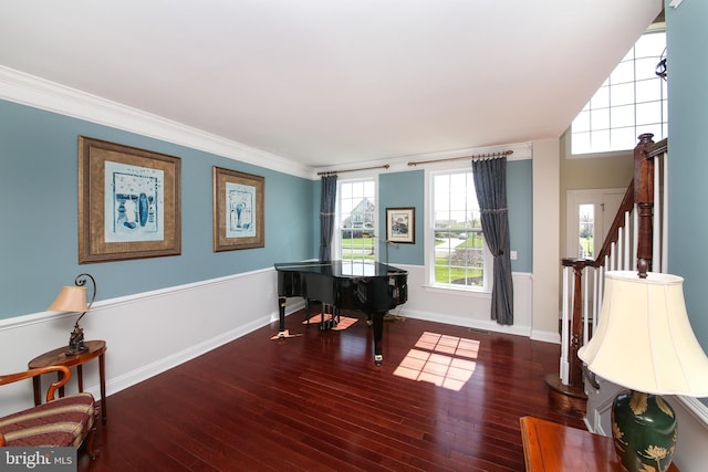 sitting room with dark hardwood / wood-style flooring and crown molding