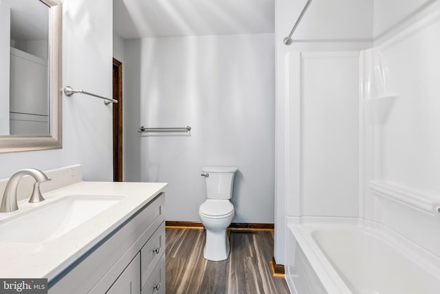 full bathroom featuring bathtub / shower combination, hardwood / wood-style floors, vanity, and toilet