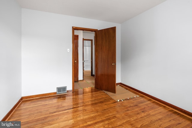 empty room with hardwood / wood-style floors