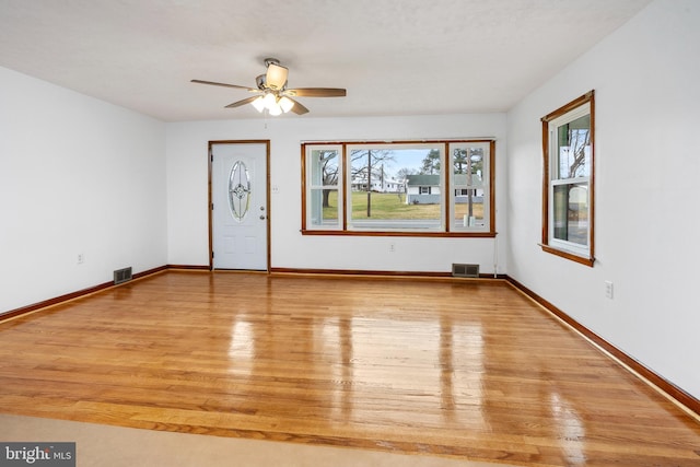 spare room featuring light wood-type flooring and ceiling fan