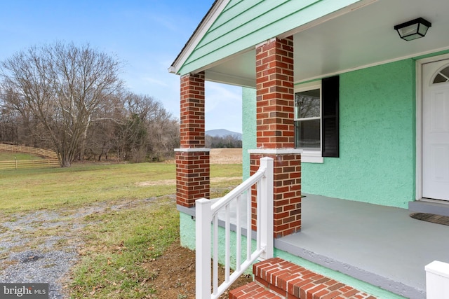 property entrance featuring a lawn