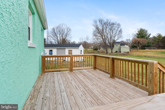 wooden deck featuring a lawn