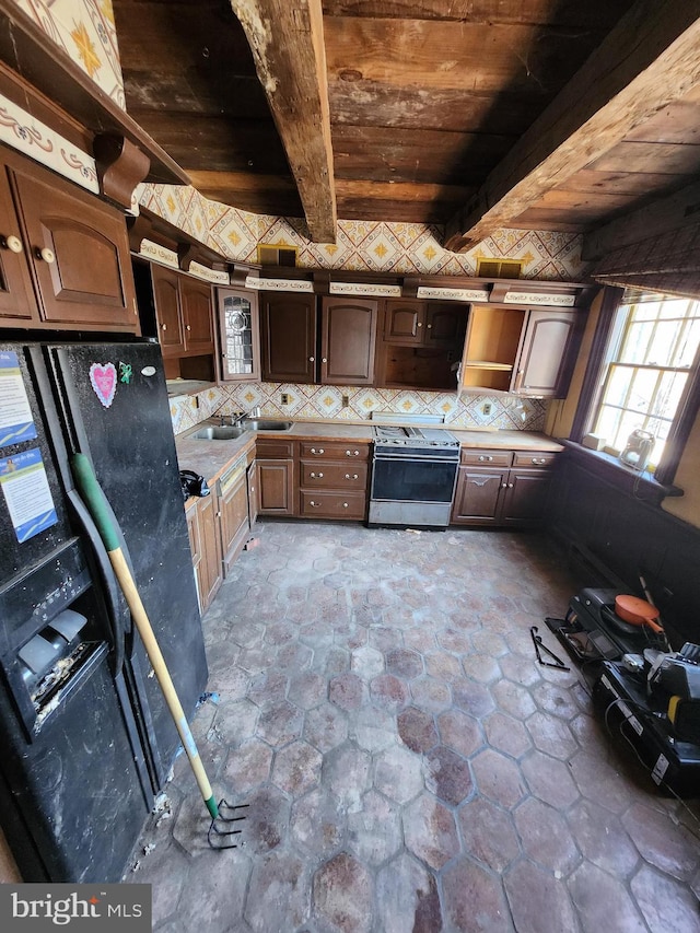 kitchen with sink, beam ceiling, wooden ceiling, black refrigerator with ice dispenser, and stainless steel electric range