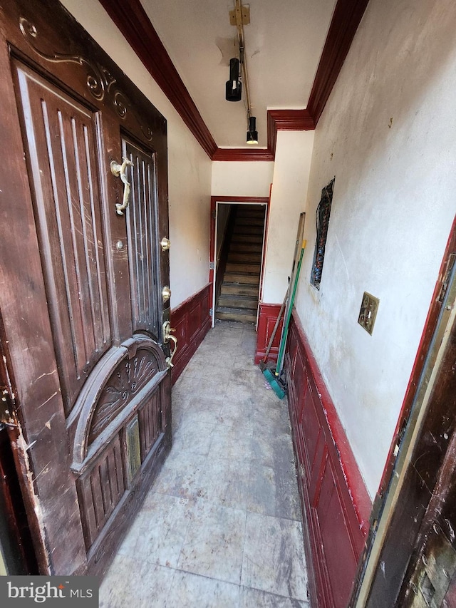 foyer entrance featuring ornamental molding