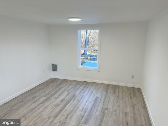 unfurnished room with light hardwood / wood-style flooring