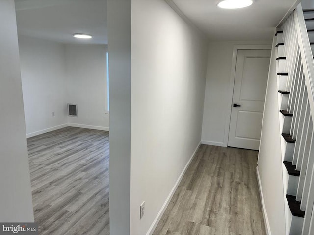 corridor with light wood-type flooring